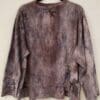 A long sleeve shirt with purple and black paint on it.