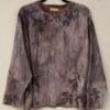 A long sleeve shirt with leaves on it.