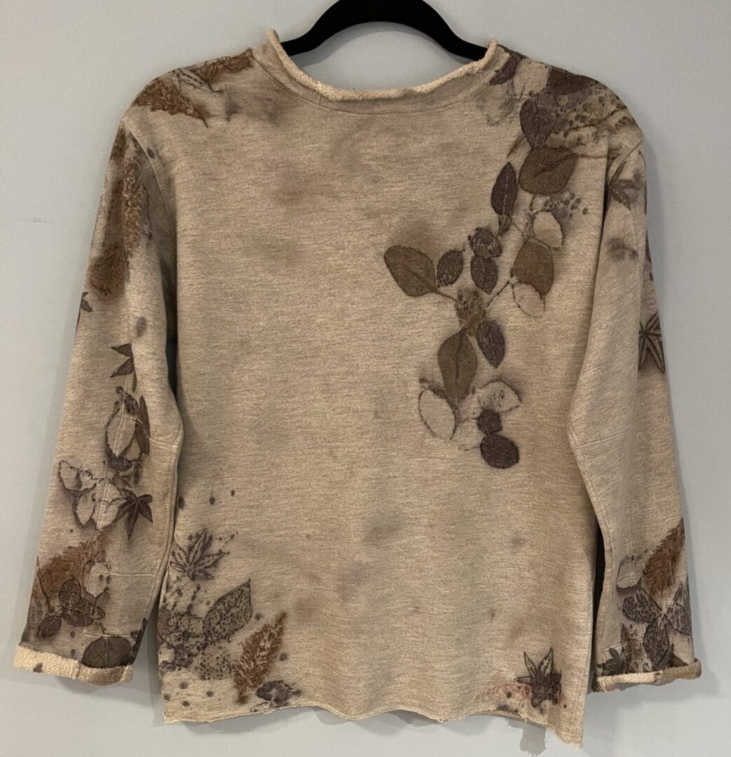 A sweater with brown flowers on it