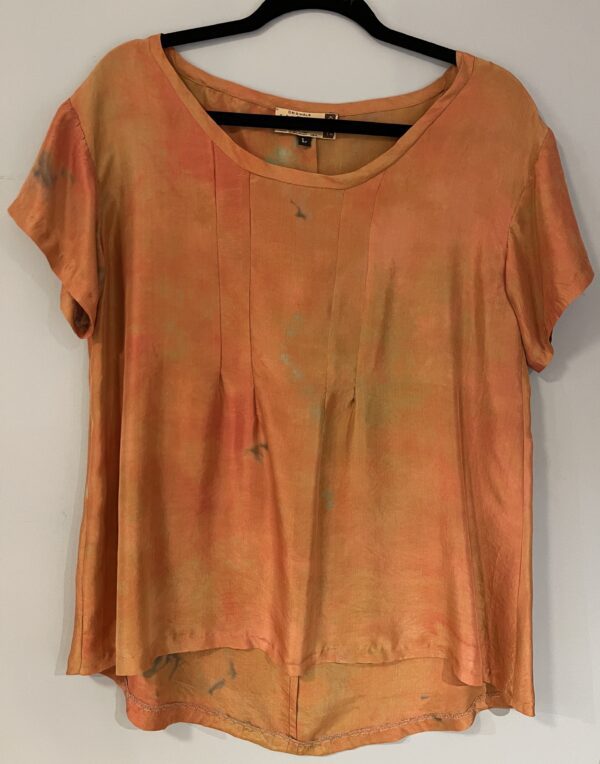 A t-shirt that is made of orange and brown fabric.