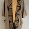 A tan jacket with black and brown designs on it.
