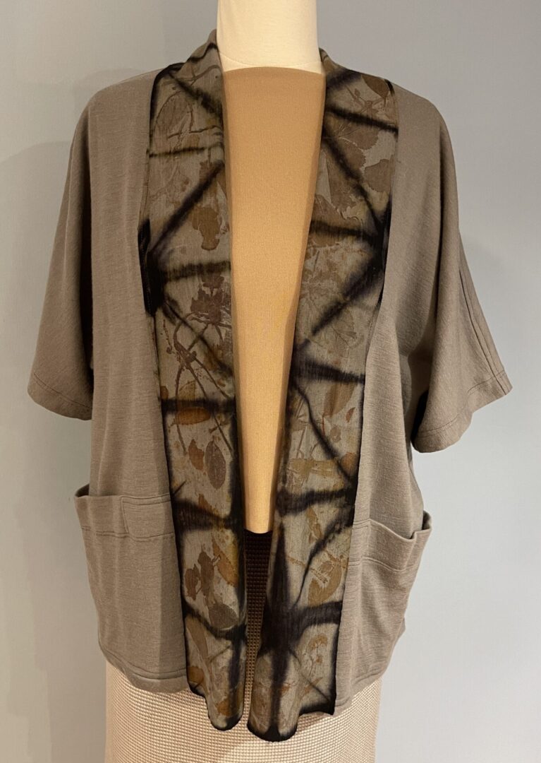 A tan jacket with black and brown designs on it.