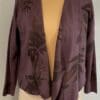 A purple jacket with black flowers on it.