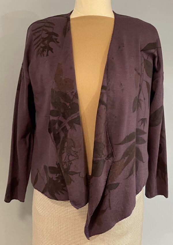 A purple jacket with black flowers on it.