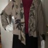 A woman 's outfit with a scarf and jacket.