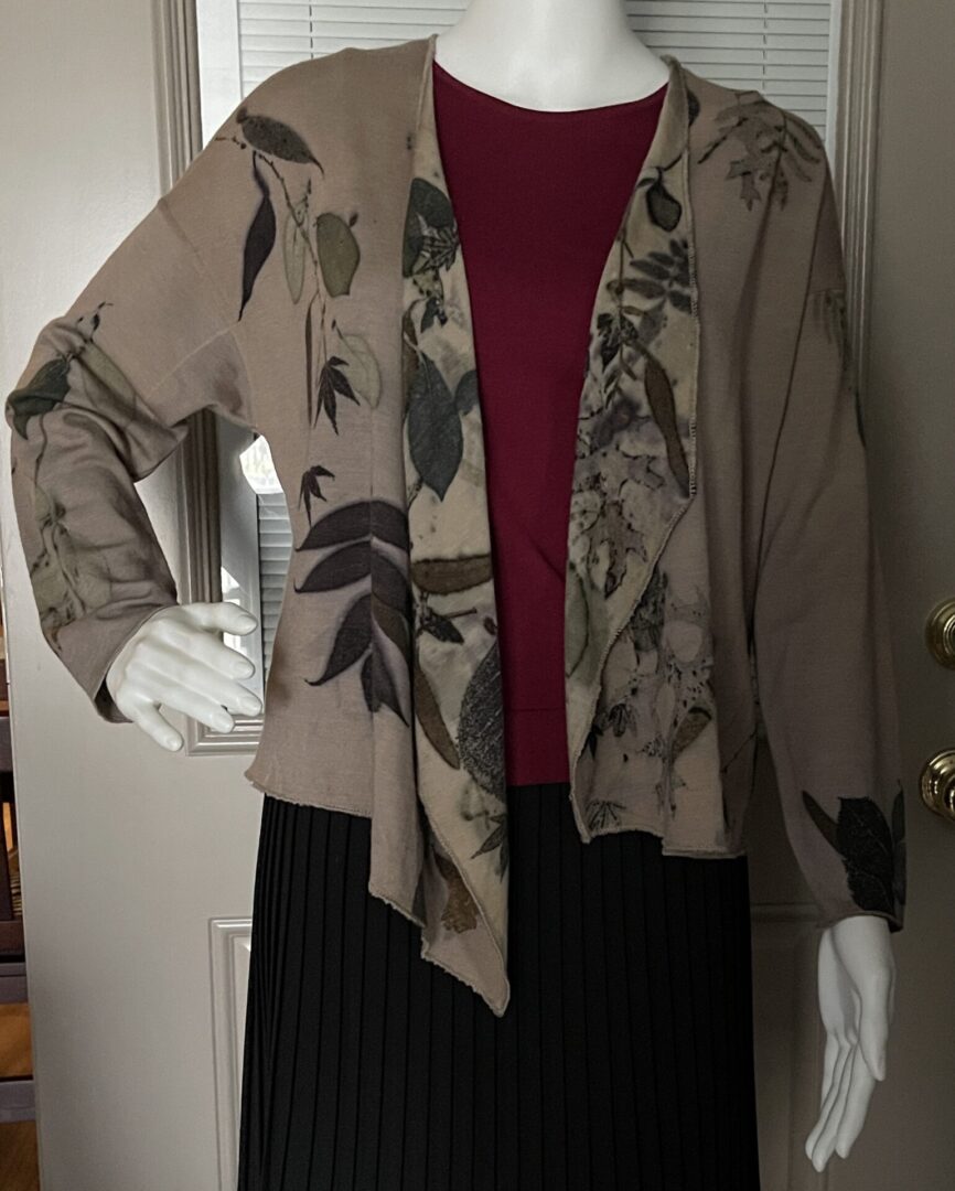 A woman 's outfit with a scarf and jacket.