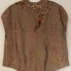 A brown shirt with some designs on it