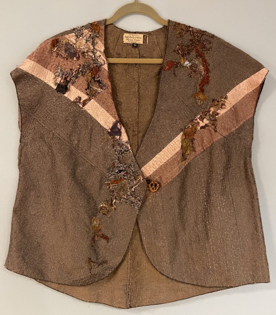 A brown vest with a floral design on it.