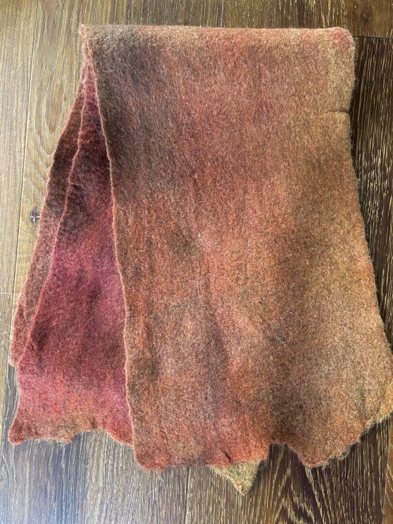 A piece of brown fabric on top of a wooden table.