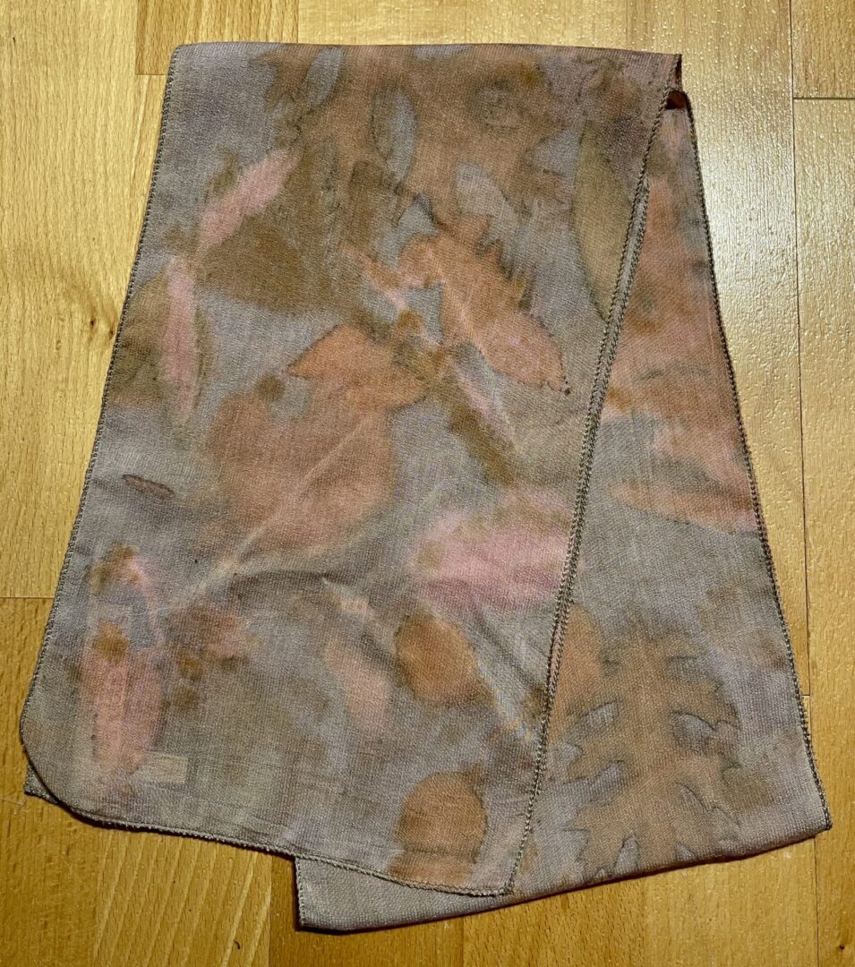 A piece of cloth with brown and pink designs on it.