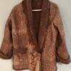 A brown jacket with a fur collar and pockets.