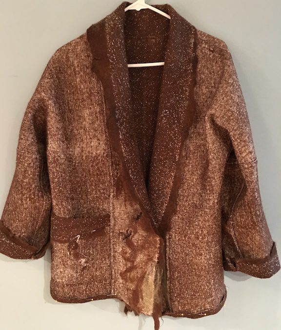 A brown jacket with a fur collar and pockets.