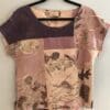 A purple and pink shirt hanging on a rack.
