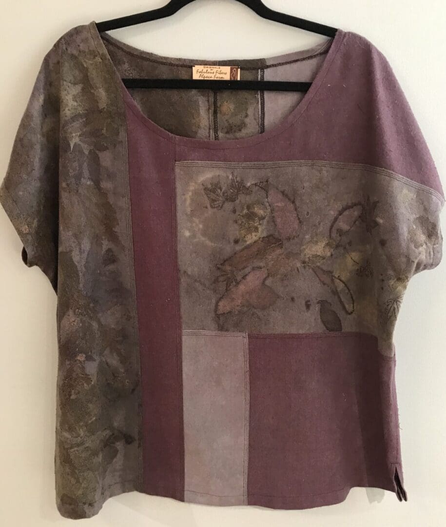 A purple and gray shirt with an elephant on it.