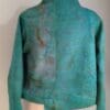 A green jacket is shown on the mannequin.