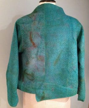 A green jacket is shown on the mannequin.