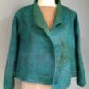 A green jacket is shown on the mannequin.