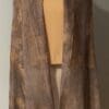 A brown and tan colored long vest with a large pocket.