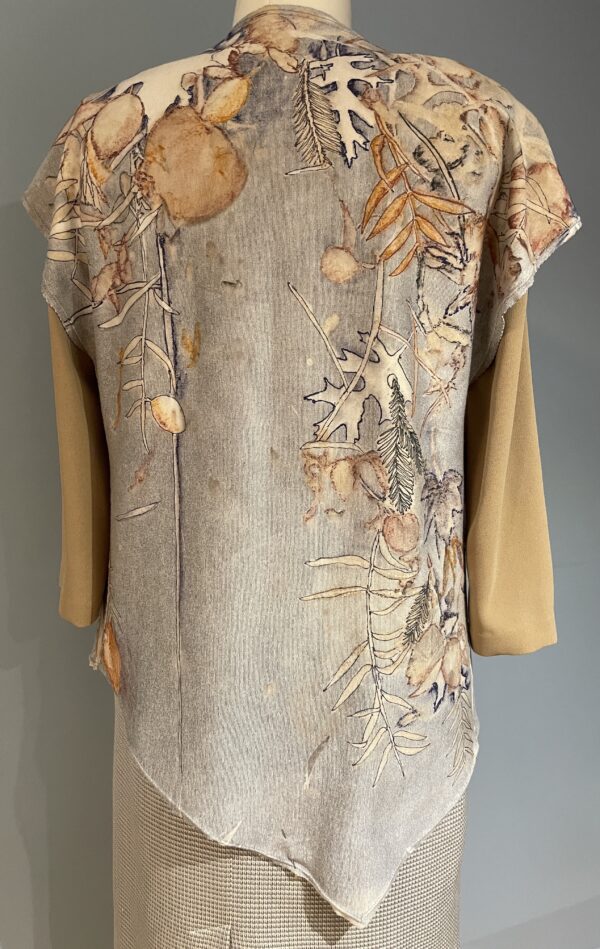 A beige and brown dress with leaves on it.