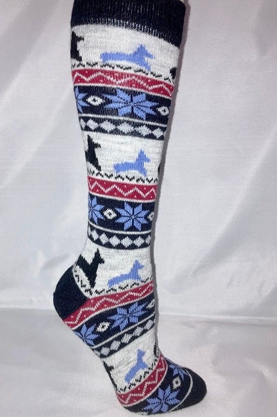 A pair of socks with reindeer and snowflakes on them.