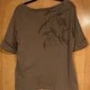 Brown short-sleeve shirt with leaf design.