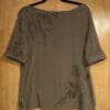 Olive green short sleeve top with leaf print.