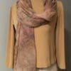 Hand-dyed silk scarf on beige top.
