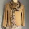 Eco-printed silk scarf on beige top.