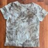 Eco-printed leaf design on teal tee.
