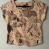 Beige linen top with leaf print.